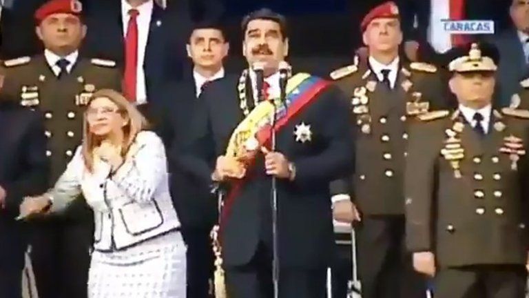 Venezuelan President Nicolás Maduro (2nd left) and his wife Cilia Flores (left) react to a loud bang during a military event in Caracas. Photo: 4 August 2018