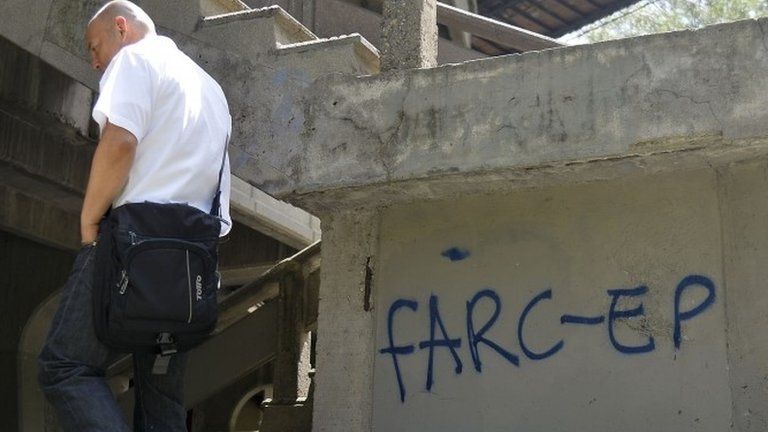 A man walks past Farc graffiti at the Antioquia university in Medellin, Antioquia department, Colombia on 23 September, 2015.