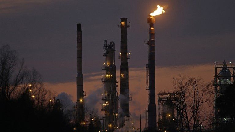 Atacks and burn-off from the Exxon Mobil refinery are seen at dusk in St Bernard Parish, Louisiana