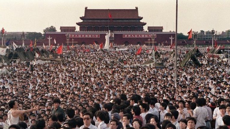 This file photo taken on 2 June 1989 shows hundreds of thousands of Chinese gathering around a 10-metre replica of the Statue of Liberty (C), called the Goddess of Democracy, in Tiananmen Square demanding democracy despite martial law in Beijing