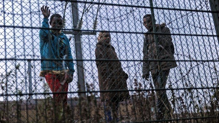 Migrants at a fence in Calais