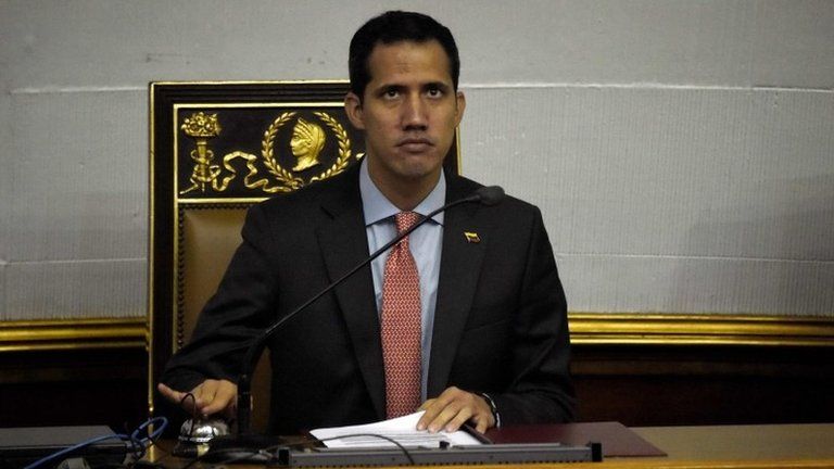 Venezuelan opposition leader and self-proclaimed acting president Juan Guaido rings a bell during a session of the Venezuelan National Assembly in Caracas on March 12, 2019