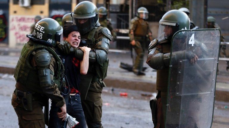 Carabineros detain a protester during demonstrations at Plaza Baquedano, in Santiago, Chile, 15 November 2019