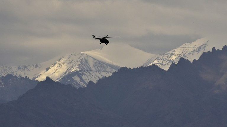 Indian air force helicopter flys above the mountains near Leh, Ladakh, India 24 June 2020.