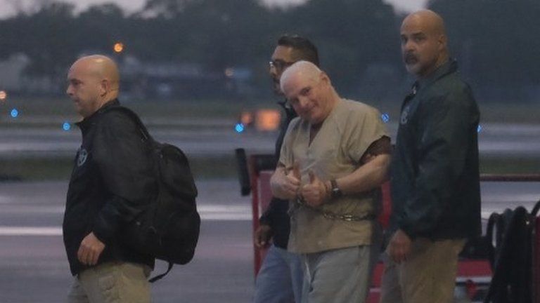 Former Panamanian President Ricardo Martinelli is escorted by US Marshals to an awaiting jet early morning June 11, 2018 at Opa Locka airport near Miami, FL