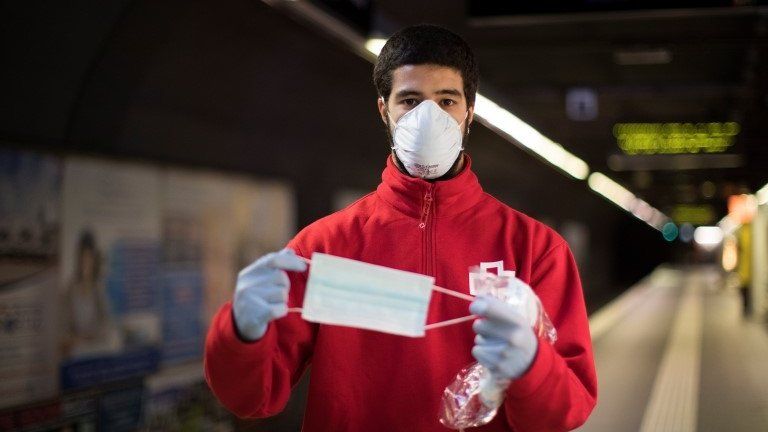 Roger, a 20-year-old Red Cross volunteer, shows a protective mask in Barcelona, Catalonia, Spain, 17 April 2020.