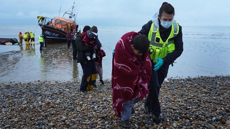 Agroup of people thought to be migrants are brought in to Dungeness, Kent