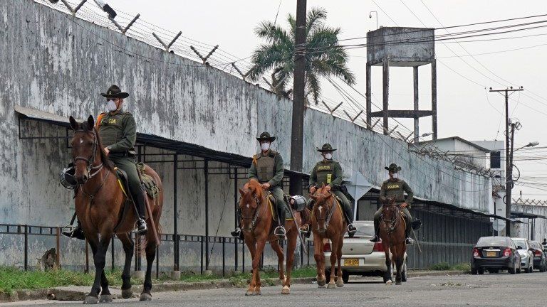 A handout photo made available by the Villavicencio Mayor's Office, shows a group of police officers patrolling the exterior of the Villavicencio Prison, in Villavicencio, Colombia, 21 March 2020