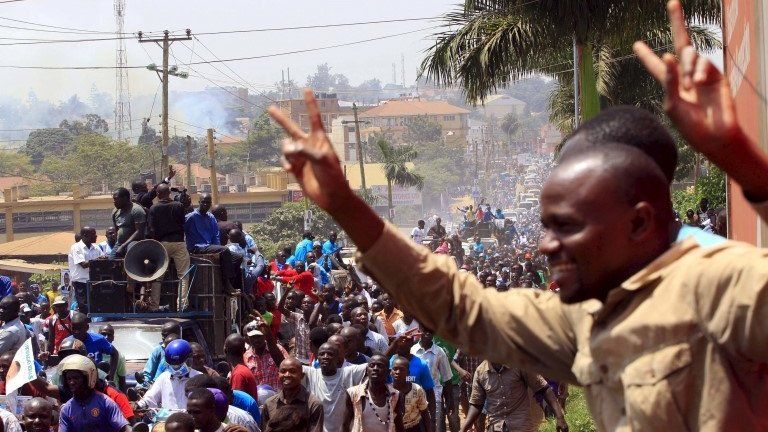 Supporters of Uganda"s main opposition presidential candidate Kizza Besigye of the Forum for Democratic Change (FDC) party march through Gaba Road during a campaign rally in the capital Kampala February 10, 2016, ahead of the Feb. 18 presidential election