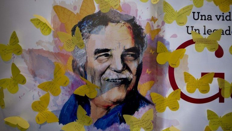A painting of Gabriel Garcia Marquez is covered by yellow butterfly cut outs with messages, placed there by fans at a bookstore on the first anniversary of his death in Mexico City. (17/04/2015)