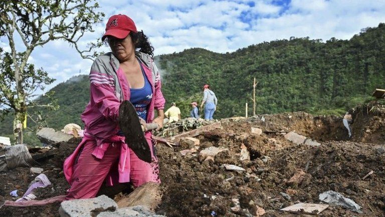 A woman searches for victims after a landslide in Rosas, Valle del Cauca department, in southwestern Colombia, on April 22, 2019