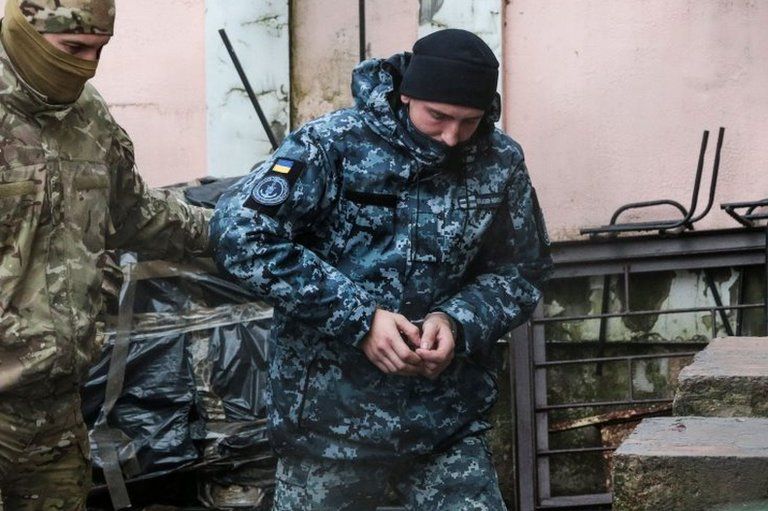 One of the detained Ukrainian sailors (C) is escorted by a Russian security service officer in Simferopol, Crimea. Photo: 27 November 2018