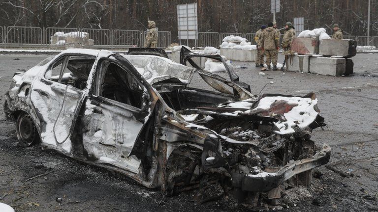 A damaged vehicle in the aftermath of an overnight shelling at the Ukrainian checkpoint in Brovary near Kyiv, Ukraine