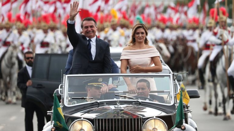 Jair Bolsonaro waves as he drives past in Brasilia, Brazil, January 1, 2019