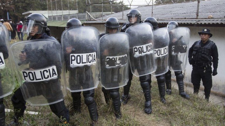 Police stand guard after a successful operation to rescue four hostages during a prison riot at the Centro Correccional Etapa II reformatory in San Jose Pinula, Guatemala