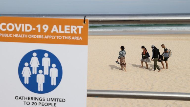A coronavirus alert sign on a beach in New South Wales