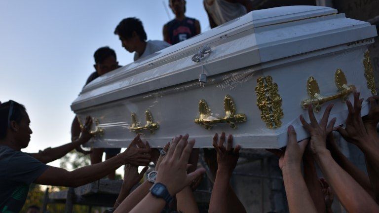 Friends and family carry the coffin of Jerico Camitan in a public cemetery on 13 November 2016 in Caloocan city, Philippines