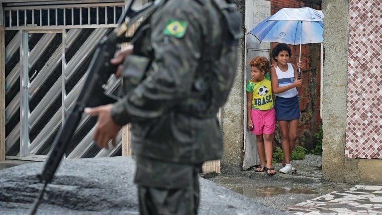 A soldier patrols close to the Vila Kennedy favela in Rio de Janeiro on February 23, 2018
