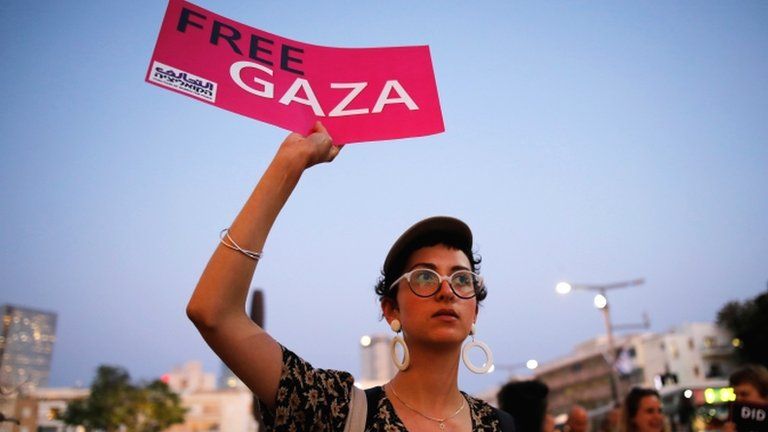 A protester holds a placard as she takes part in a demonstration calling for an end to Israel's policy towards Gaza and a boycott of the 2019 Eurovision Song Contest in Tel Aviv, 14 May 2019
