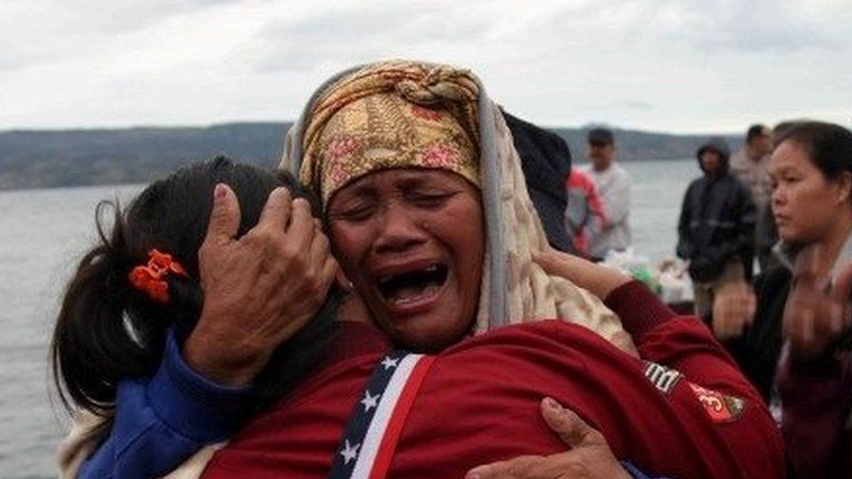 Relatives cry while waiting for news on missing family members who were on a ferry that sank yesterday in Lake Toba, at Tigaras Port, Simalungun, North Sumatra, Indonesia June 19, 2018.