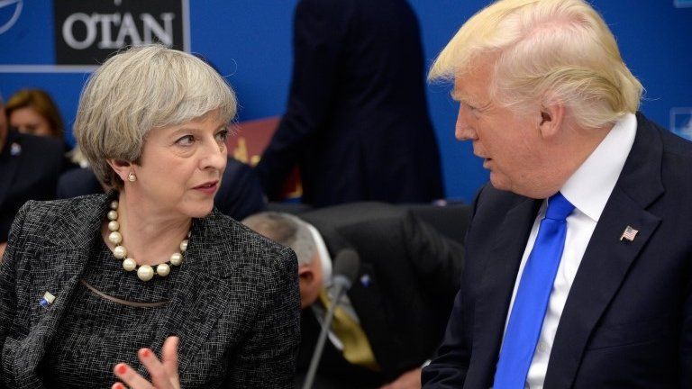 US President Donald Trump (R) speaks with British Prime Minister Theresa May during a working dinner meeting at the NATO summit in Brussels