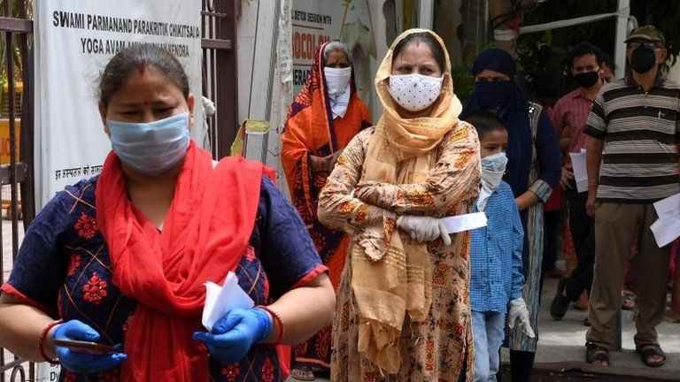 People with coronavirus symptoms wait in queue for a COVID-19 test at an ayurvedic hospital during a lockdown imposed as a preventive measure against the spread of the COVID-19 coronavirus in New Delhi on May 29, 2020.