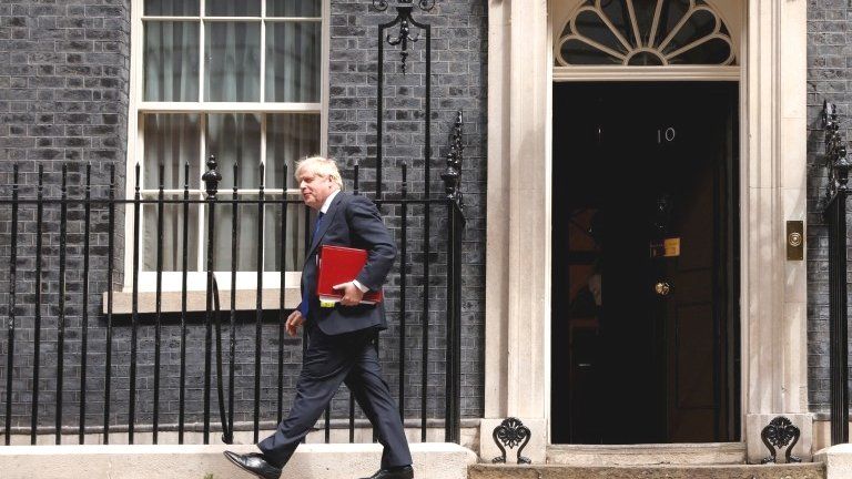 British Prime Minister Boris Johnson walks away from Downing Street, in London, July 6, 2022
