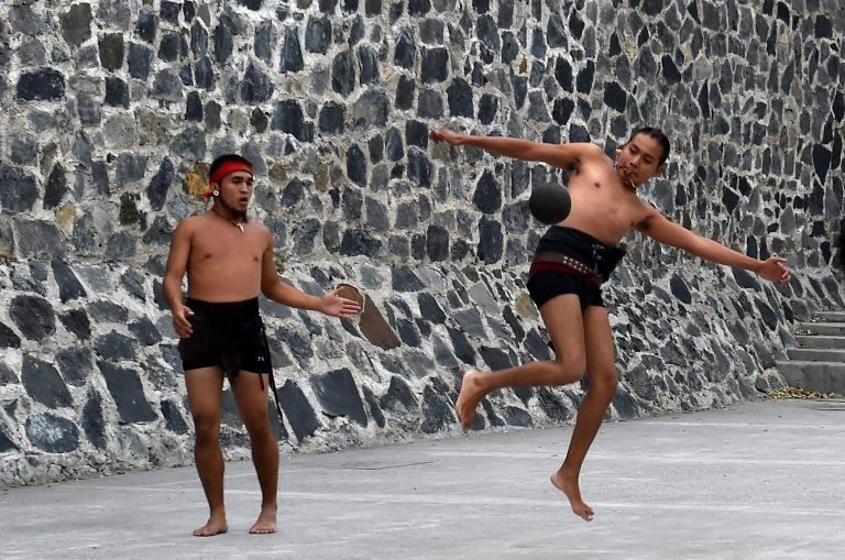 Men play a pre-Columbian ballgame called "Tlachtli" -in Nahuatl indigenous language- which rule is to hit a "Ulamaloni" (solid rubber ball) with the hip or shoulder, during a match at the FARO Poniente cultural centre in Mexico City on August 21, 2019.