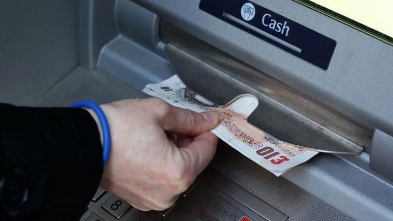 Money being taken out of an ATM
