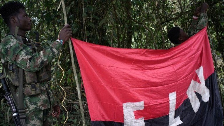Rebels of the National Liberation Army (ELN) hold a banner in the northwestern jungles in Colombia, August 30, 2017