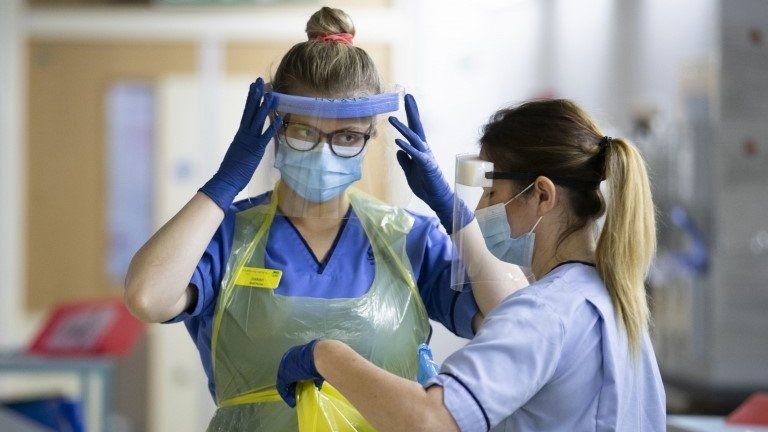 Nurses changing PPE