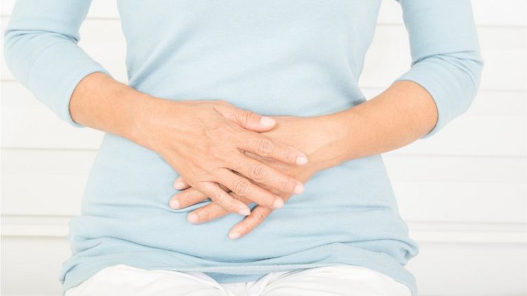 Woman holding her hands on her tummy