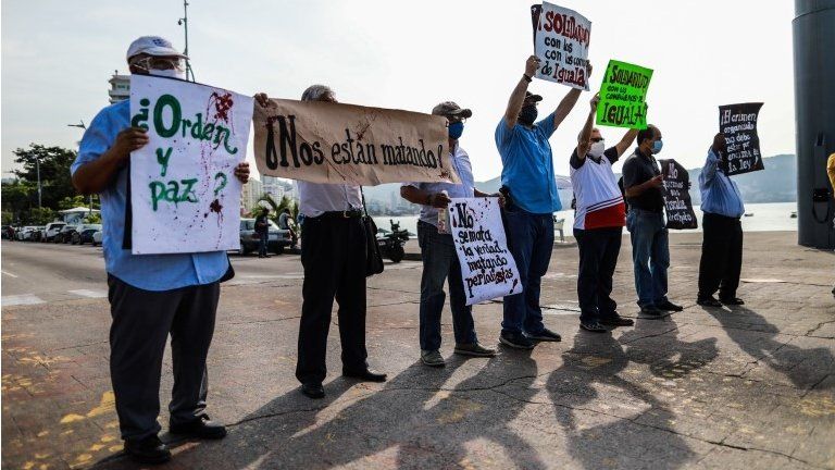 Mexican journalists hold placards during a protest demanding protection after colleagues were threatened by organized crime, in Acapulco, Mexico, 16 October 2020