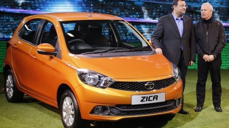 Chairman of Tata Group, Cyrus Mistry and Tata Motors" Head of Advanced and Product Engineering, Tim Leverton (R), pose with a Zica car during its launch at the Indian Auto Expo in Greater Noida, on the outskirts of New Delhi, India, February 3, 2016.