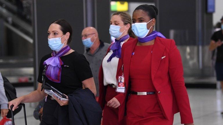 Virgin Australia flight crew is seen in a baggage collection area at Tullamarine Airport in Melbourne, Australia, 08 January 2021.