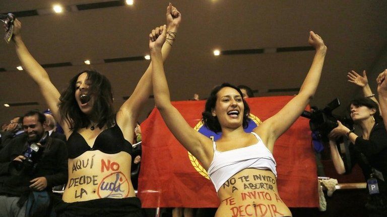 Two women celebrate the approval of the abortion bill in the Chilean Chamber of Deputies