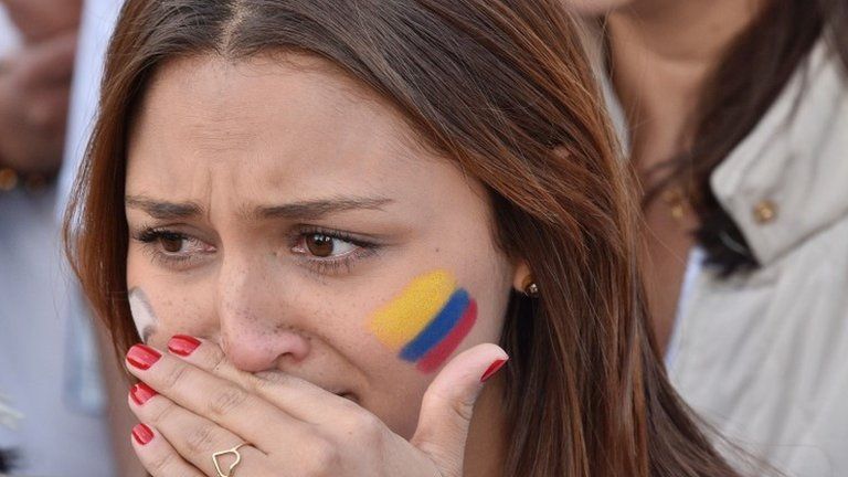 A Colombian woman wipes away her tears in Bogota"s Bolivar main square on September 26, 2016, during celebrations for the historic peace agreement between the Colombian government and the Revolutionary Armed Forces of Colombias (FARC).