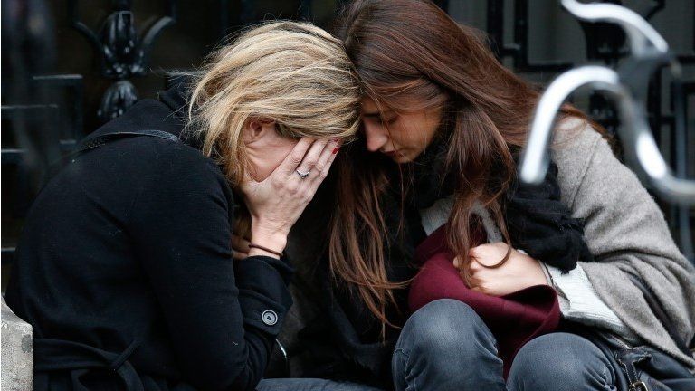 Two women cry in a location near the Bataclan concert venue in Paris, France, 14 November 2015