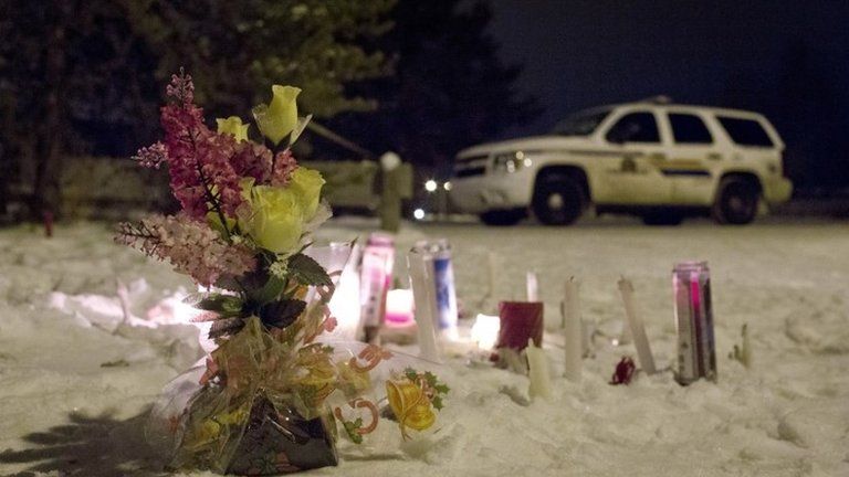 Candles and flowers placed as a memorial lay near the La Loche, Saskatchewan, junior and senior high school