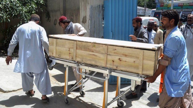 Pakistani security officials and hospital staff move a dead body into a morgue in Quetta on May 22, 2016, transported to the hospital following a drone strike in the remote town of Ahmad Wal in Balochistan that targeted Afghan Taliban Chief Mullah Akhtar Mansour.