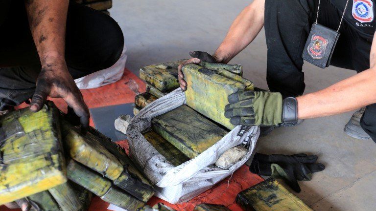 Police officers check packages of cocaine that were hidden in a shipment of six charcoal containers that were to be shipped to Israel after being seized by an anti-narcotics unit in the Terport de Villeta port in Villeta near Asuncion, Paraguay, October 20, 2020.