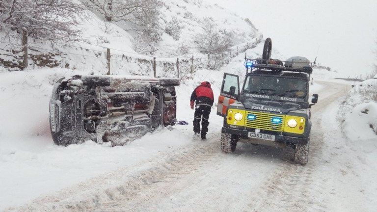 The Woodhead mountain rescue team check an overturned car