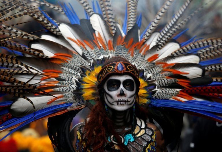 A woman dressed as a Catrina take part in a Catrina parade ahead of Day of the Dead in Mexico City