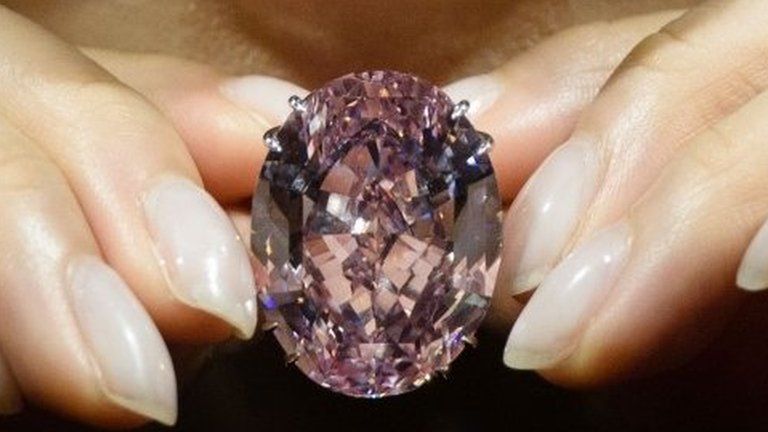 A model poses with a 59.60-carat oval mixed-cut pink diamond, known as "The Pink Star", during a Sotheby"s media preview in Hong Kong on March29, 2017