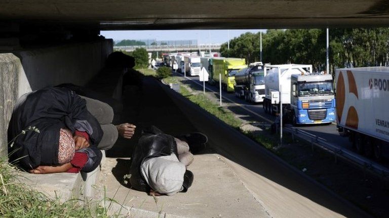 Migrants lying by the roadside in France