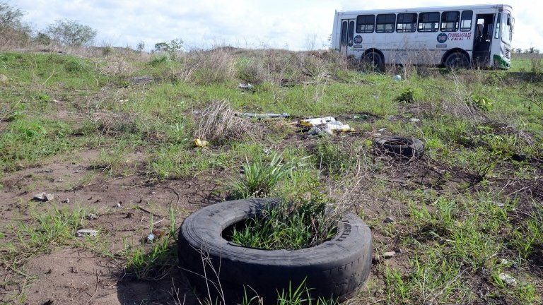 A general view shows a bus (back) at a field as members of the General Prosecutor"s Office of the State of Veracruz (unseen) prevented access to the Colinas de Santa Fe in Veracruz, Mexico, 14 March 2017