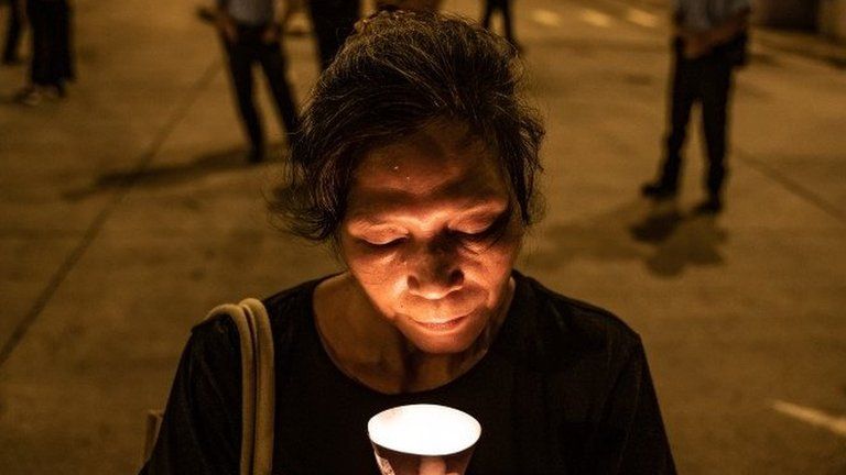Woman with candle in Hong Kong on Wednesday
