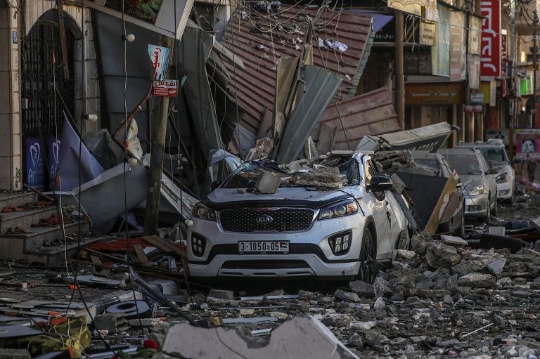 A crushed car in the aftermath of an Israeli airstrike on Gaza City