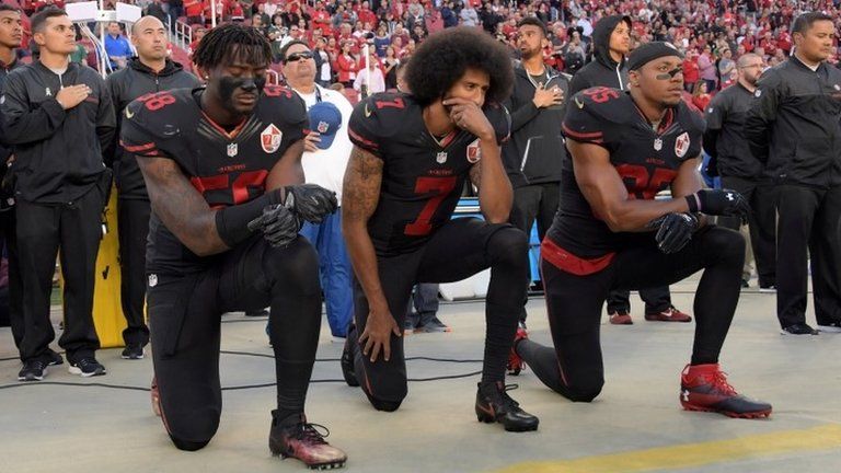 San Francisco 49ers outside linebacker Eli Harold (58), quarterback Colin Kaepernick (7) and free safety Eric Reid (35) kneel during the US national anthem