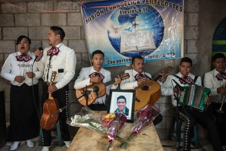 A Christian mariachi sings at the wake of Elfego Roliberto Miranda, one of the 16 Guatemalan migrants who died in Tamaulipas, Mexico, in Comitancillo, Guatemala 13 March 2021